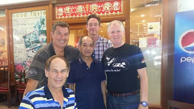 Singapore tradition: Qantas pilots, including Richard Woodward (right), outside their local Fatty's, with co-owner Skinny (centre).