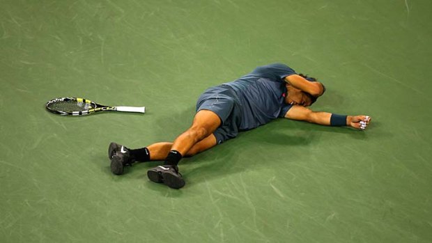 Phenomenon: Rafael Nadal slumps to the court after claiming his 13th grand slam title at the US Open.