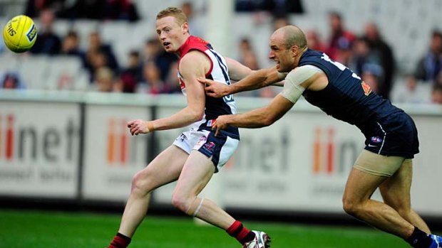 Kicking on: Melbourne youngster Sam Blease kicked his first goal in the AFL yesterday, despite the best efforts of the likes of Carlton champion Chris Judd.