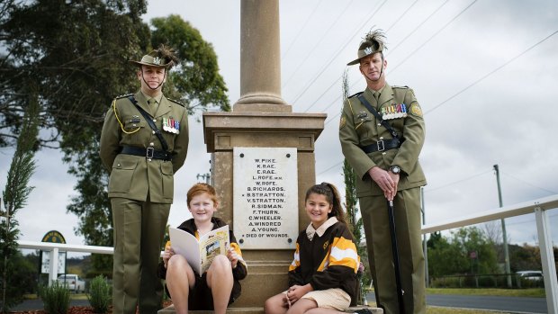 Lest we forget: Captain Nick Hornbuckle (left), Mount Hunter public school students Issac Latham and Chantel Wright and Sergeant Major Tony Lynch in front of the Mount Hunter World War I memorial.