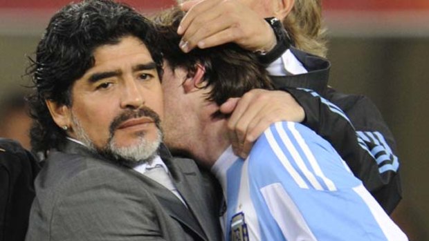 Hard to take ... Diego Maradona hugs Argentina's striker Lionel Messi after the loss to Germany.