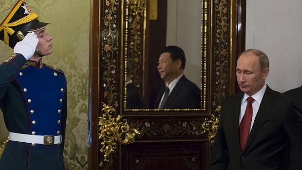 Russia's President Vladimir Putin is followed by his Chinese counterpart Xi Jinping