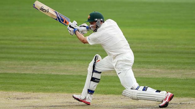 On the drive ... Mike Hussey sends another Sri Lankan delivery hurtling through the covers during his eventful century on the second day of the first Test at Hobart.