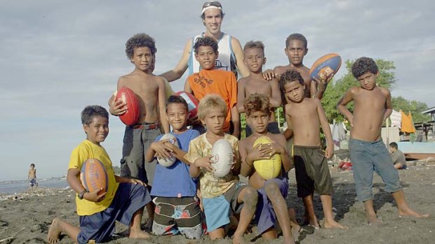 Helping junior AFL players at the Lord Howe settlement in Honiara, Solomon Islands.