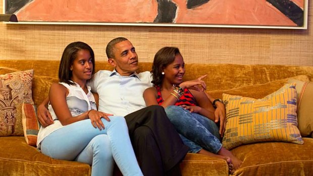 Fan base ... Barack Obama and his daughters, Malia, left, and Sascha, watch the first lady deliver her speech.