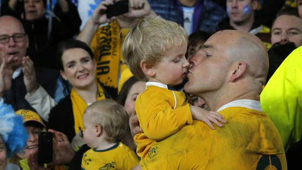 Genuine: Australian captain Stephen Moore kisses his son Theodore after his team's win over Argentina.