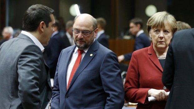 Greek Prime Minister Alexis Tsipras talks to European Parliament President Martin Schulz and Germany's Chancellor Angela Merkel on Thursday in Brussels.