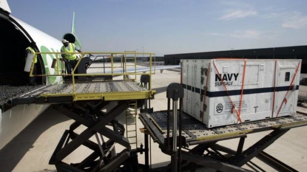 A US Navy black box locator is loaded on to a plane.