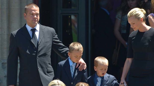Lachlan Murdoch and his wife, Sarah, with their children, outside the cathedral.