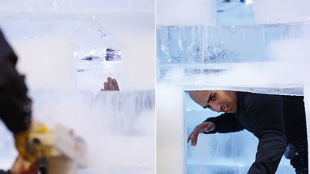 After an assistant cuts into the ice cell, Israeli illusionist Hezi Dayan steps out early today  after a record-breaking  64 hours.