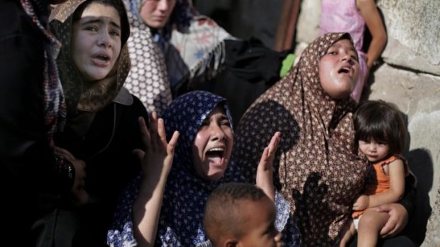 Palestinian relatives of four boys from the same extended Bakr family, grieve during their funeral in Gaza City.