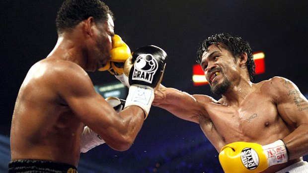 Manny Pacquiao (right) of the Philippines lands a punch during his welterweight title fight with Shane Mosley.