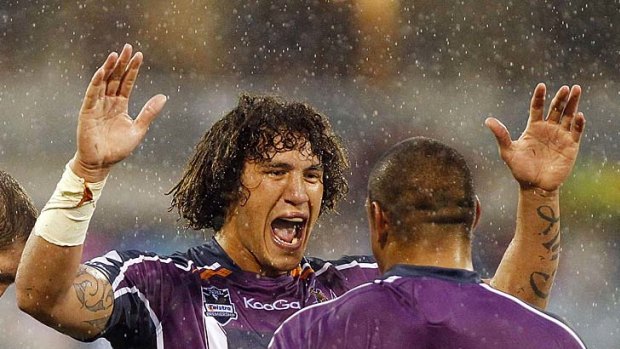 Kevin Proctor and Sika Manu of the Storm celebrate after winning the round one match against the Canberra Raiders.