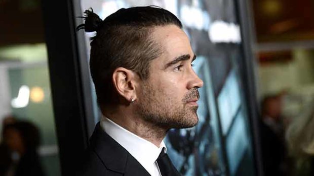 Colin Farrell sports a mini bun.