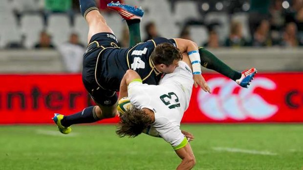 JJ Engelbrecht of South Africa is tackled by Tommy Seymour.