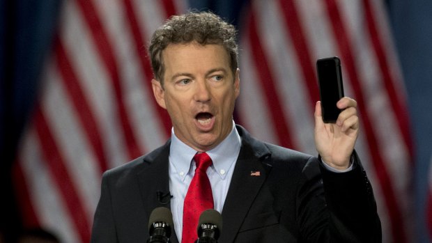 Republican senator Rand Paul holds up his phone as he speaks before announcing the start of his presidential campaign in Louisville, Kentucky, in April. Senator Paul has emerged as a key critic of US surveillance powers. 