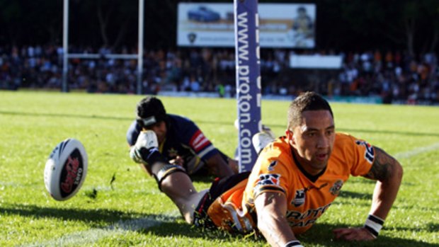 Big score ... Benji Marshall scores for the Tigers last year and now he has scored for himself with a $2 million four-year contract extension which will see him cross the line at Leichhardt many, many more times.
