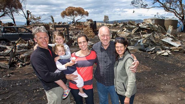The Holmes family, who had to shelter underneath a jetty to escape the recent bushfire on Tasmania's east coast,  at their property near Dunalley today.