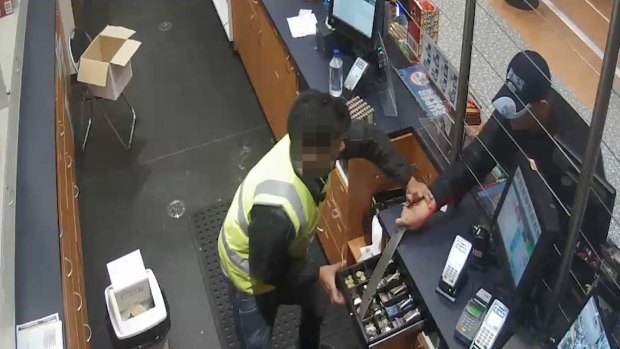 Police have released CCTV footage of a man who robbed a Gold Coast service station wearing a New South Wales Blues cap.