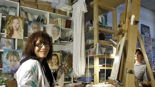 Archibald finalist Anna Minardo in her Windsor studio, painting one of 196 portraits for a portrait marathon to raise money for multiple sclerosis.