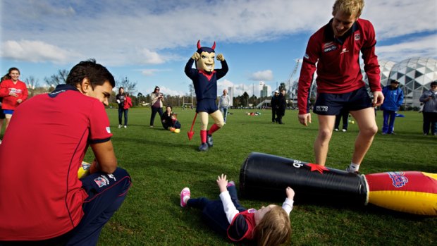 Melbourne players, pictured hosting an all-girl NAB AFL Auskick clinic, need to improve their use of the ball, says Garry Lyon.
