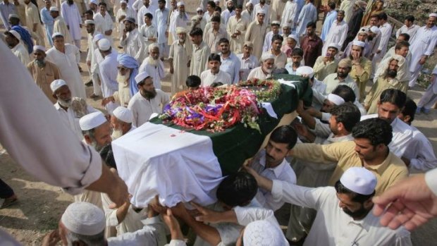 Relatives carry the coffin of a fire fighter who was killed during a gun battle against militants at the Mehran naval aviation base in 2011.