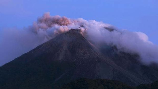 Mount Merapi emits smoke as it is seen from Kali Tengah village near Yogyakarta.