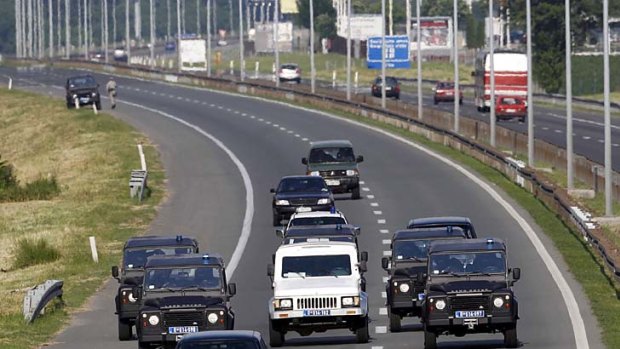 Ratko Mladic is transported from a Belgrade courthouse and jail complex to Belgrade airport in a white armoured vehicle with a police convoy.