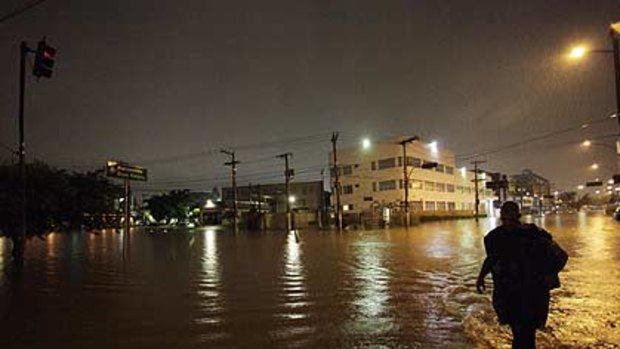 A man walks through a flooded street after heavy rains in Barra Funda, Sao Paulo.
