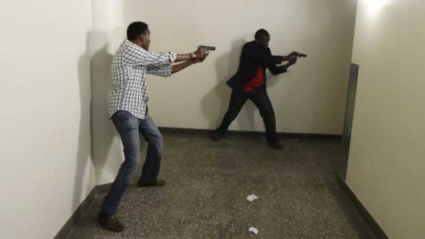 Kenyan police search the Westgate mall in Nairobi for the gunmen.