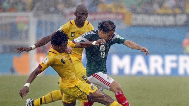 Mexico's Andres Guardado, right, is challenged by Cameroon's Jean Makoun in Natal.