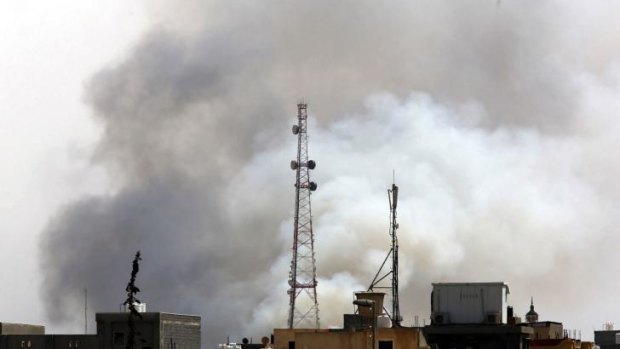 Smoke billows from a petrol depot that has been ablaze four days following clashes between rival militias near the airport in the Libyan capital Tripoli.