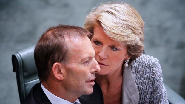 Julie Bishop talks to Prime Minister Tony Abbott. The Coalition says the Environment Department will provide independent advice and analysis on climate change.