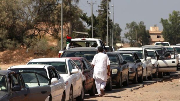 Shortages &#8230; motorists wait for fuel in a 1km line in disputed Zawiyah.