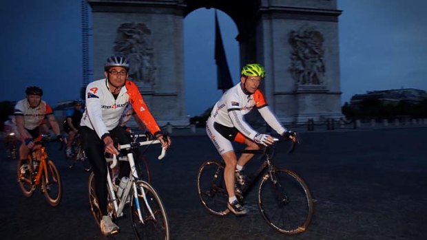 Wheel deal: Tony Abbott cycles past the Arc de Triomphe in support of an Australian ex-services charity.