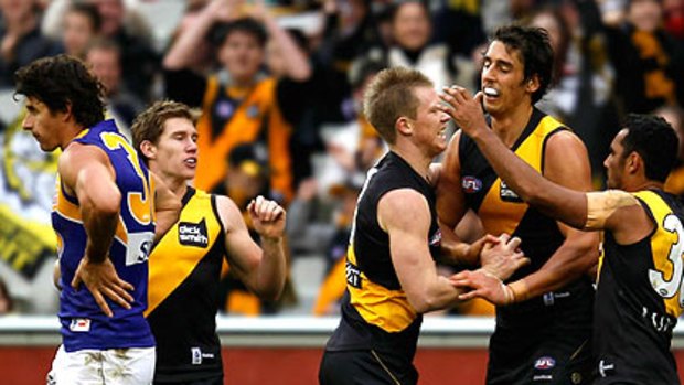 Richmond players congratulate Jack Riewoldt on his way to a 10-goal haul against the West Coast Eagles.