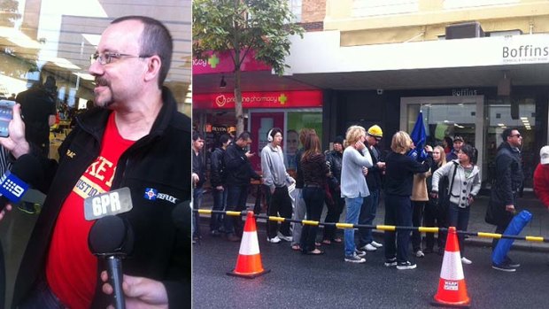 Stephen Quayle speaks to the media after getting the first iPhone 5; and Apple afficionados queue in the rain to get their new phones.