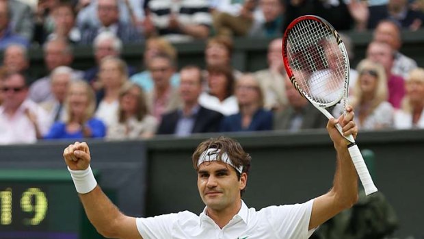 Roger Federer celebrates after defeating Novak Djokovic.