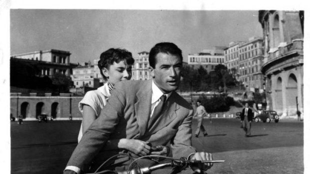 Italian adventure: Audrey Hepburn and Gregory Peck ride a motor scooter  in <i>Roman Holiday</i>. 