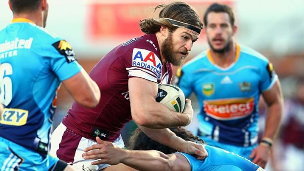 Get back up: David Williams of the Manly Sea Eagles is tackled during Sunday's match with the Gold Coast Titans.