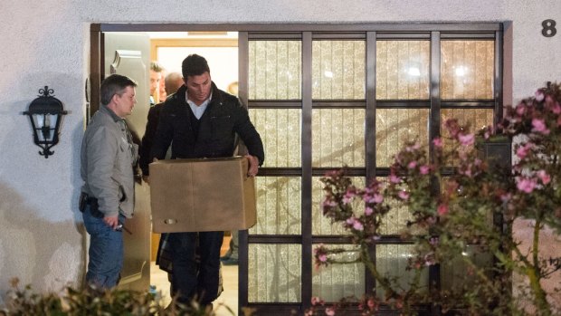 Investigation under way: Police carry a computer, a box and bags out of the residence of the parents of Andreas Lubitz, co-pilot on Germanwings flight 4U9525, in Montabaur, Germany.