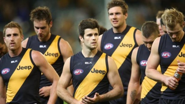 Trent Cotchin leads the Richmond team off after it was carved up by Hawthorn.