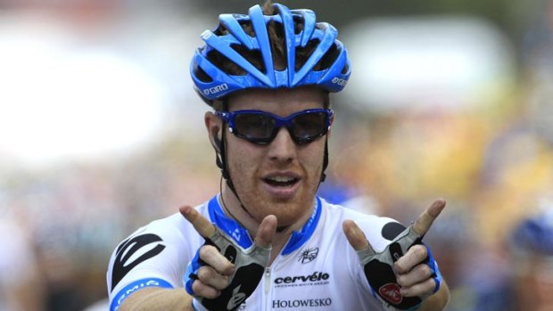Tyler Farrar, of the USA, forms a "W'' as he crosses the finish line to win the third stage of the Tour de France.