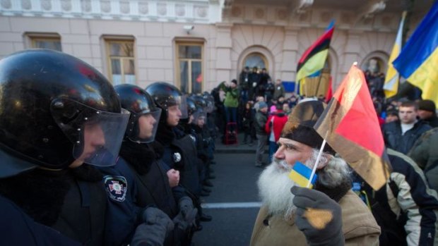 A protester confronts riot police in the Ukrainian capital of Kiev.