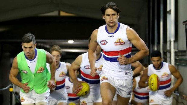 Ryan Griffen leads the Bulldogs onto the ground.