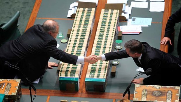 Hands across the sea ... the Immigration Minister, Chris Bowen, right, and the opposition immigration spokesman, Scott Morrison, in Parliament yesterday.