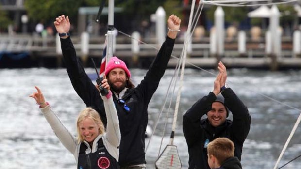 British adventurer David de Rothschild celebrates with members of his crew Jo Royle, left, and Dave Thomson shortly after their Plastiki catamaran docked at the Sydney Maritime Museum.
