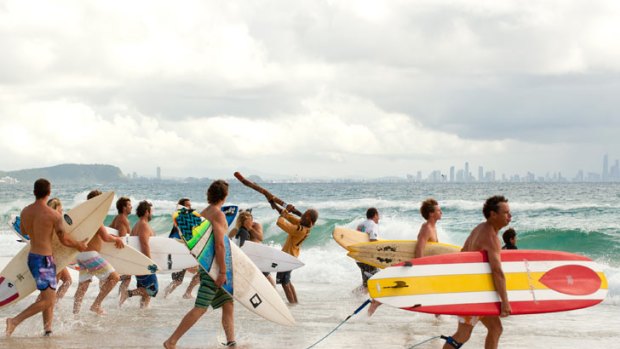 Surfers prepare for the paddle out at the Michael Peterson memorial held at Kirra Beach.