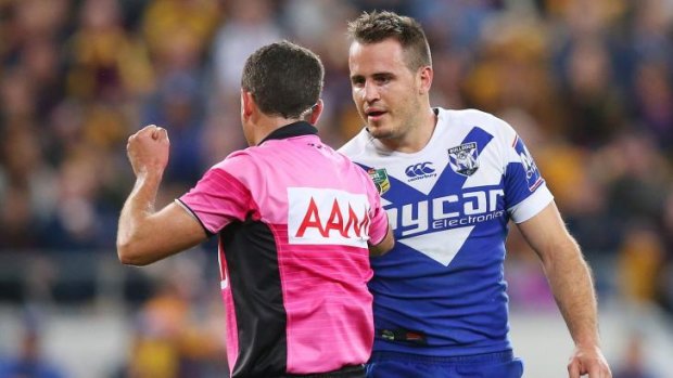 Dressing down: Josh Reynolds gets a talking to from referee Gerrard Sutton during the Bulldogs' 41-10 loss to Brisbane on Friday night.