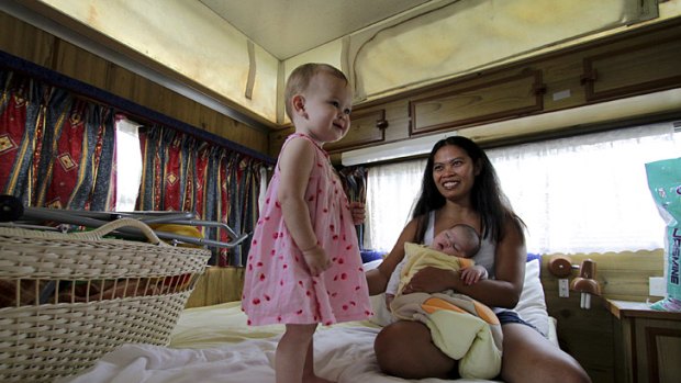 Surviving ... Janet Owens in her caravan with daughters Hannah and Chloe.
